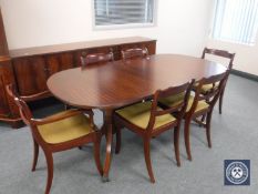 A reproduction inlaid mahogany eight-piece dining room suite