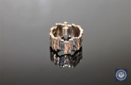 A 9ct gold bark-textured band ring, size N/O CONDITION REPORT: 10.