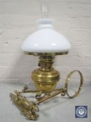 A Victorian brass wall-mountable oil lamp with bracket,