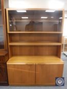 A 20th century teak display cabinet fitted cupboards