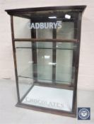 An antique counter top shop display cabinet with Cadbury's Chocolate advertising