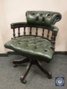 A green buttoned leather Chesterfield style swivel low backed desk chair, width 62 cm.