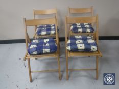 Four folding kitchen chairs with cushions and a pine wall rack