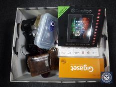 A box containing telephones, vintage camera,