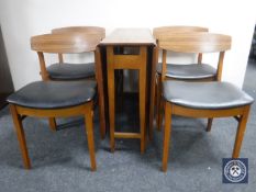 A mid 20th century Beautility drop leaf table and four chairs