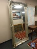 An ornate silvered rectangular bevelled mirror,