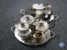 Two 20th century oval plated twin-handled serving trays containing plated tea set and set of cased