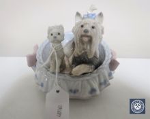 A Lladro figure of two terriers in a basket