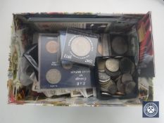 A box of assorted cigarette cards, crowns, foreign coins, £5 coin, 5 dollar coin,