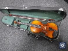 A 1/4 size child's violin in case with bow