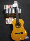 A box of DVD's together with an acoustic guitar