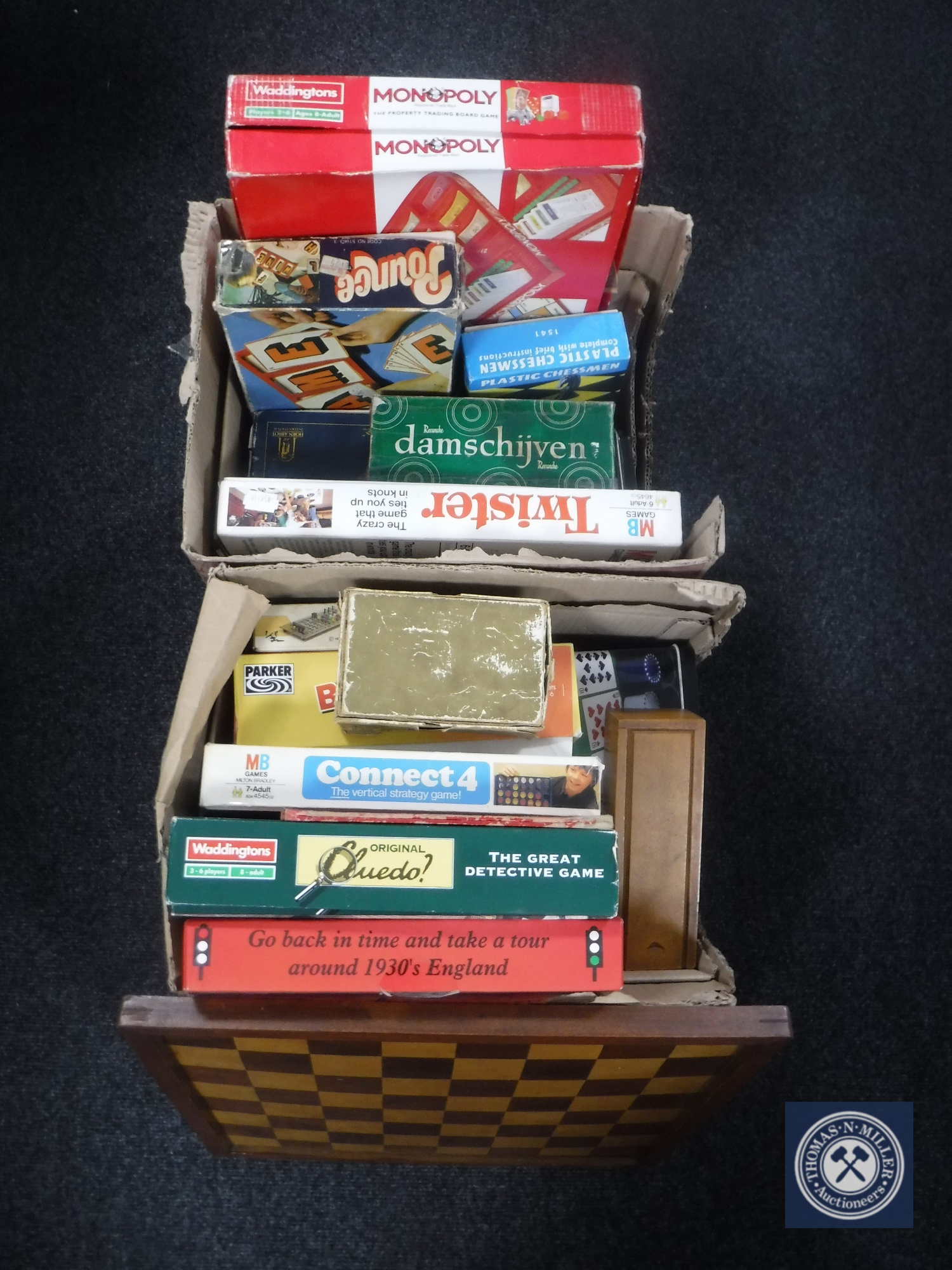 A box of assorted board games,