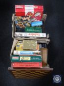 A box of assorted board games,