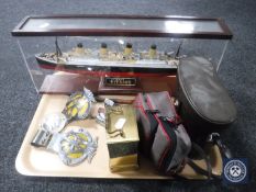 A tray containing wooden model of the Titanic in display case, brass carriage clock, AA badges,