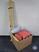 A box containing a roll of gold-coloured fabric together with nine assorted cushions