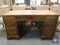A late Victorian mahogany twin pedestal desk,