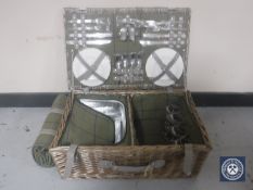 A wicker picnic basket with travel rug
