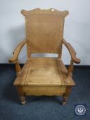 An early 20th century pine commode chair