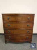 A reproduction mahogany bowfronted chest of four drawers,