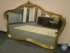 An ornate gilt framed overmantel mirror,