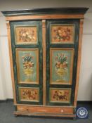 A continental pine two-door cabinet painted with panels of flowers and fruit,