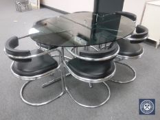 A 20th century tubular metal dining table base with oval smoked glass top,