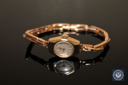 A lady's 9ct gold wristwatch on gold expanding strap