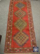 A Caucasian design rug on red ground,