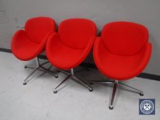 Three red upholstered reception chairs on chrome bases