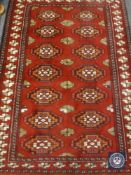 A Caucasian design rug on red ground,