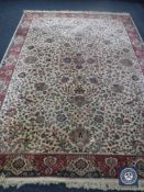 A machine made fringed floral carpet on cream ground