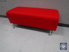 A red upholstered over size reception footstool