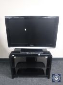 A Panasonic Viera 32 inch LCD TV with remote on stand