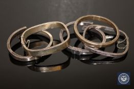 Four sterling silver and one white metal bangle (5) CONDITION REPORT: All bangles