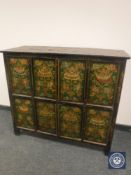 An Eastern polychrome painted four-door low cabinet,