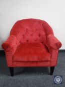 An armchair in red button dralon