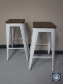A pair of metal and wood topped breakfast bar stools - white
