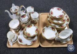 Two trays containing sixty-two pieces of Royal Albert Old Country Roses tea and dinner ware