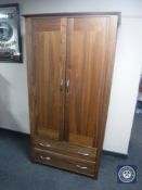 A double door wardrobe fitted two drawers in a rosewood finish