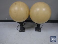 A pair of outdoor lights with shades