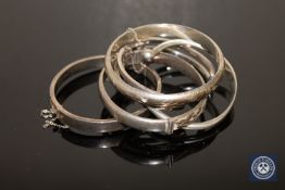 Four sterling silver and one white metal bangle (5)