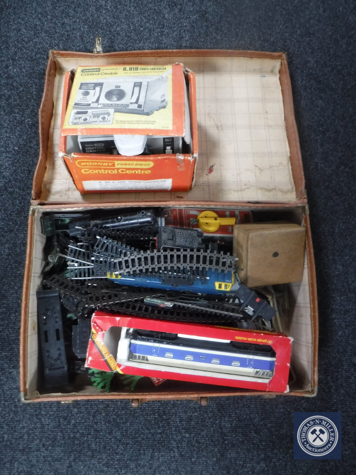 A vintage leather case containing Hornby rolling stock, track,