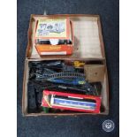 A vintage leather case containing Hornby rolling stock, track,