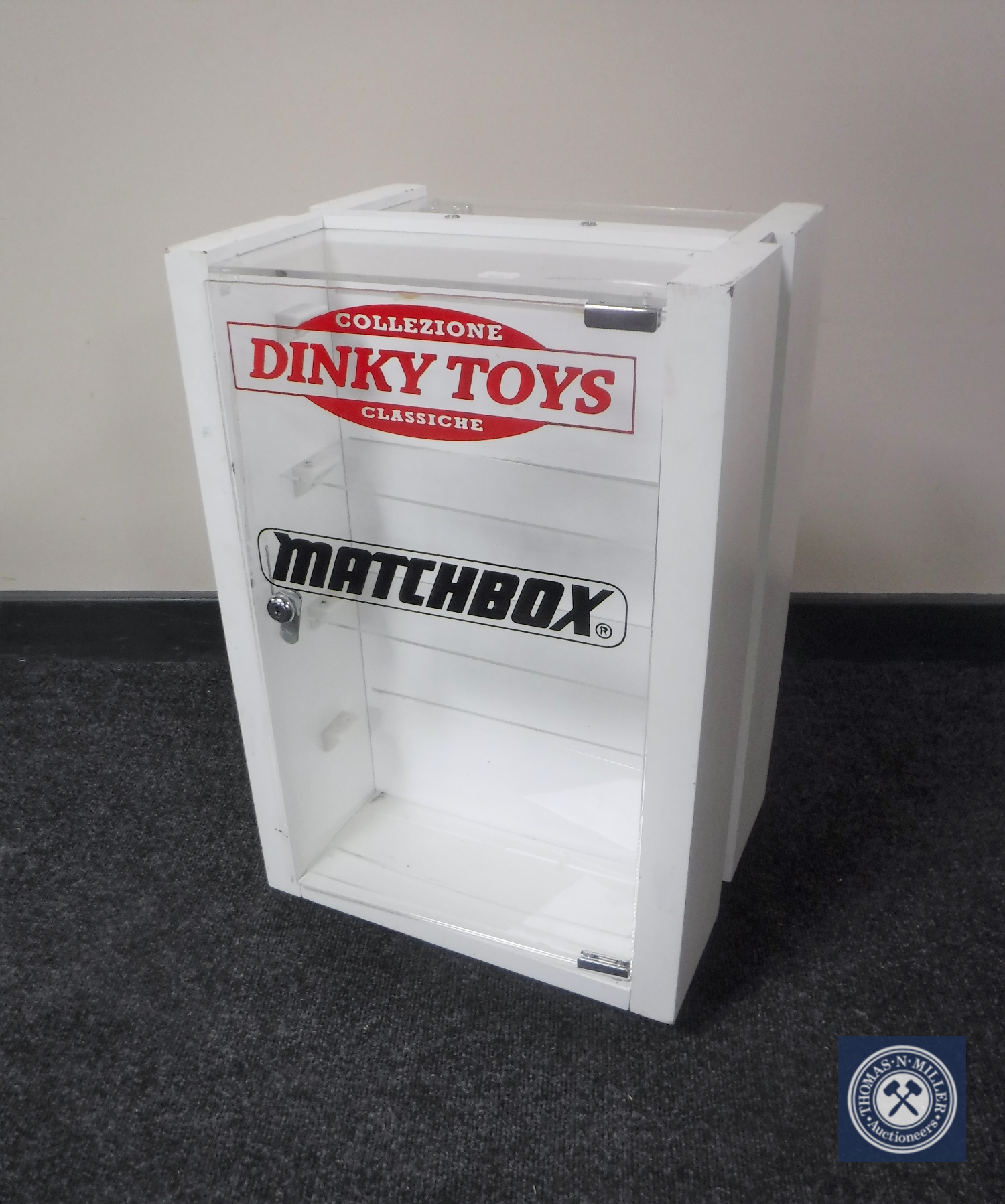 A revolving counter top display cabinet bearing "Dinky Toys and Matchbox"