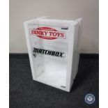 A revolving counter top display cabinet bearing "Dinky Toys and Matchbox"