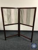 An Edwardian mahogany fire screen