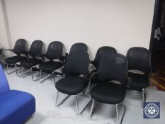 Eight black office armchairs