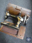 A cased vintage Singer hand sewing machine