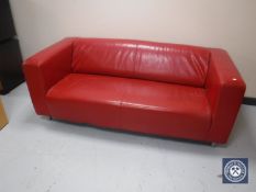 A red leatherette two seater settee