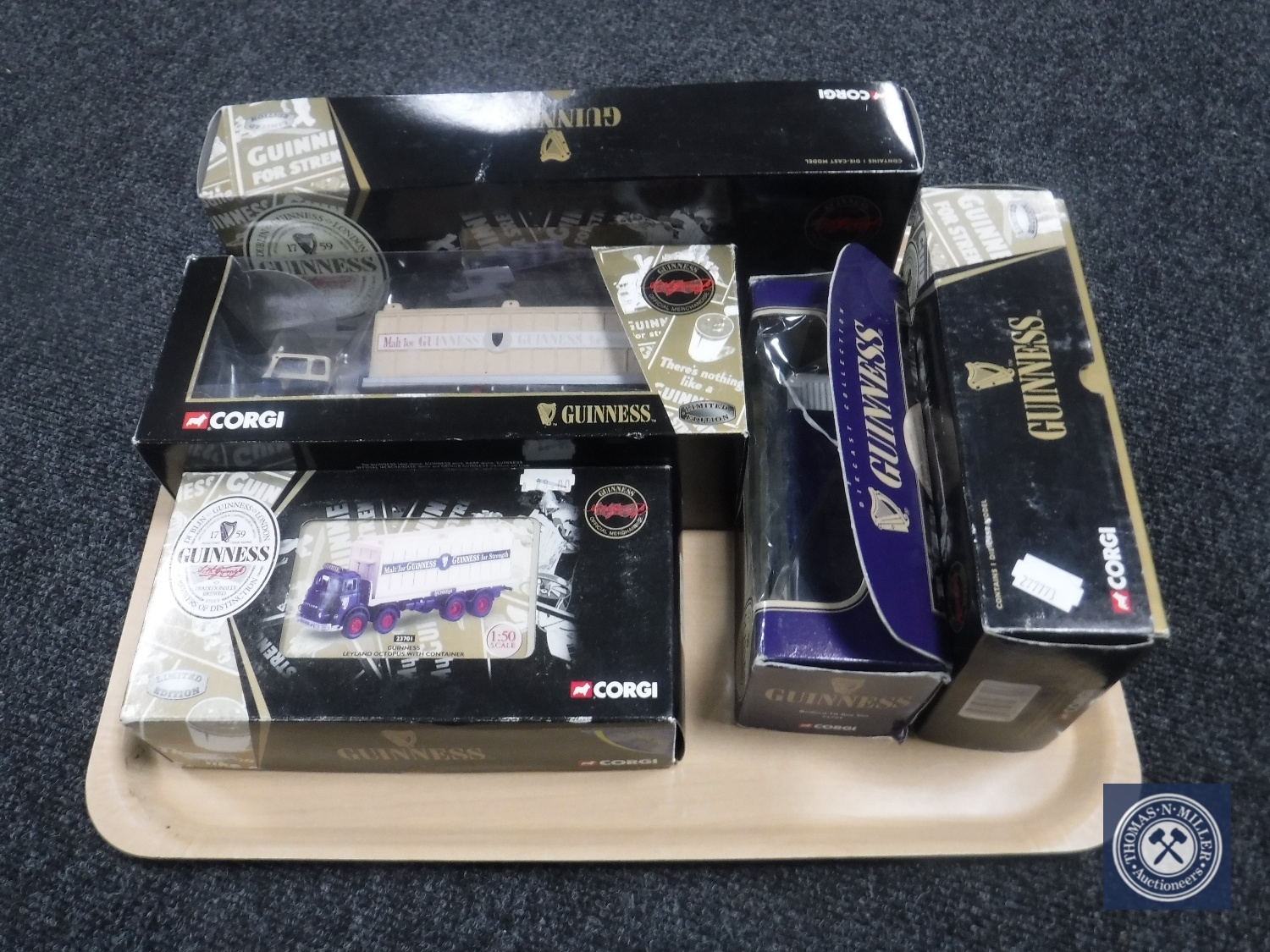 A tray containing five boxed Corgi Guinness die cast wagons